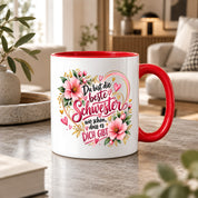 Herzbotschaft Schwester Tasse – Du bist die beste Schwester, wie schön dass es dich gibt – Kaffeetasse 330 ml mit rosa Blumen und Herzen – Geschenk für Schwester zum Geburtstag, Weihnachten, als Dankeschön oder kleine Aufmerksamkeit