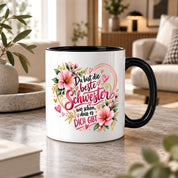 Herzbotschaft Schwester Tasse – Du bist die beste Schwester, wie schön dass es dich gibt – Kaffeetasse 330 ml mit rosa Blumen und Herzen – Geschenk für Schwester zum Geburtstag, Weihnachten, als Dankeschön oder kleine Aufmerksamkeit