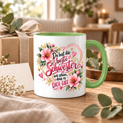Herzbotschaft Schwester Tasse – Du bist die beste Schwester, wie schön dass es dich gibt – Kaffeetasse 330 ml mit rosa Blumen und Herzen – Geschenk für Schwester zum Geburtstag, Weihnachten, als Dankeschön oder kleine Aufmerksamkeit